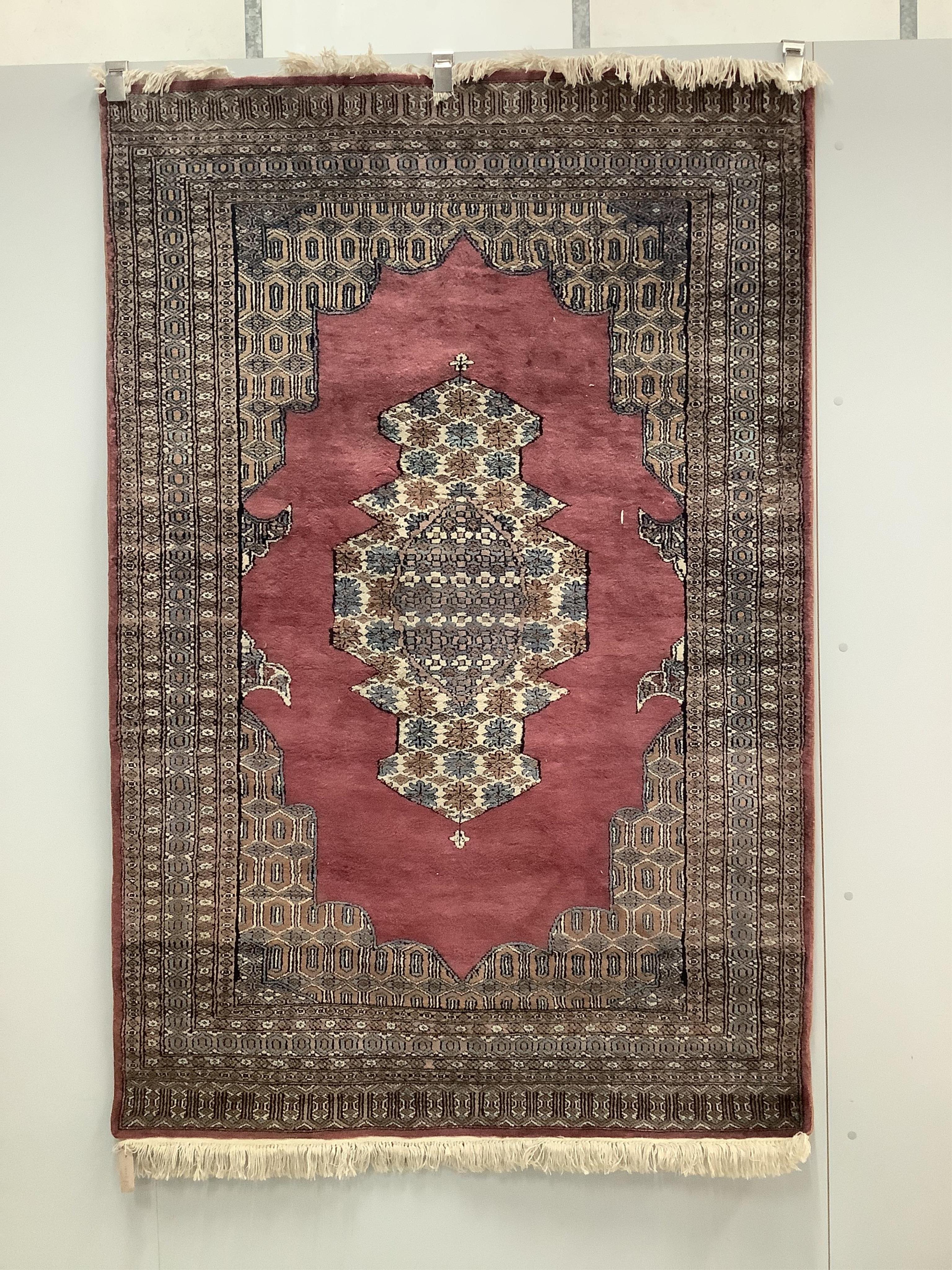 A modern Persian puce ground rug, 185 x 124cm. Condition - good